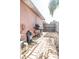 The side yard features a BBQ grill and some brick pavers leading to the backyard at 7812 Turnbridge Dr, Port Richey, FL 34668