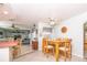Inviting dining area with an adjacent breakfast bar and open view to the living room at 7812 Turnbridge Dr, Port Richey, FL 34668