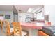Bright kitchen with white cabinets, modern appliances, and a breakfast bar with seating at 7812 Turnbridge Dr, Port Richey, FL 34668