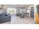Comfortable living room featuring neutral tones, tile flooring, plush seating, and an abundance of natural light at 7812 Turnbridge Dr, Port Richey, FL 34668
