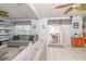 Open living room with neutral tones, large windows, and sliding glass doors to the outdoor space at 7812 Turnbridge Dr, Port Richey, FL 34668
