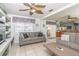 Inviting living area featuring comfortable seating, ceiling fans, and lots of natural light at 7812 Turnbridge Dr, Port Richey, FL 34668