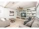 Spacious living room with custom built-in shelves, ceiling fan and comfortable seating at 7812 Turnbridge Dr, Port Richey, FL 34668