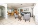 Open-concept living room with tile floors, comfortable seating, and bright, airy dining area at 7812 Turnbridge Dr, Port Richey, FL 34668