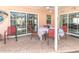 Covered patio includes a table and chairs, ideal for outdoor dining and entertaining, and multiple sliding glass doors at 7812 Turnbridge Dr, Port Richey, FL 34668