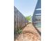 The side yard features a wood fence and leads to the backyard at 7812 Turnbridge Dr, Port Richey, FL 34668