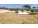 Back of home featuring sliding glass door that leads to the patio and yard at 8130 129Th N Ln, Seminole, FL 33776