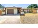 Charming single-story home featuring a well-kept lawn, attached garage, and inviting front entrance at 8130 129Th N Ln, Seminole, FL 33776