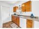 Well-lit kitchen featuring wood cabinets, countertops, and a white dishwasher with natural light from the window at 8130 129Th N Ln, Seminole, FL 33776