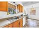 Bright kitchen with wood cabinets and countertops, with a view into the dining area at 8130 129Th N Ln, Seminole, FL 33776
