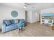 Bright living room featuring a comfortable sofa, a ceiling fan, and modern decor at 8130 129Th N Ln, Seminole, FL 33776