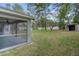 Large backyard with a screened patio and mature trees offering plenty of shade at 8408 Nuzum Rd, Brooksville, FL 34613