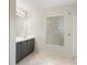 Bathroom featuring double sinks, a large mirror, and a window with blinds at 8408 Nuzum Rd, Brooksville, FL 34613