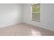 Bedroom with a tile floor and a window with view to the outdoors at 8408 Nuzum Rd, Brooksville, FL 34613