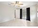 Bright bedroom with tile floors, black out curtains, and a ceiling fan at 8408 Nuzum Rd, Brooksville, FL 34613