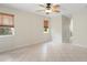 Bedroom featuring tile floors, a ceiling fan, and windows with wood blinds at 8408 Nuzum Rd, Brooksville, FL 34613