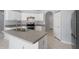 Bright kitchen featuring white cabinets, stainless steel appliances, and a center island with a double sink at 8408 Nuzum Rd, Brooksville, FL 34613
