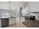 Kitchen featuring stainless steel appliances, white cabinets and island with a double sink under a ceiling fan at 8408 Nuzum Rd, Brooksville, FL 34613