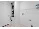 Laundry area with a white wire shelf, washer hook-ups, and utility door at 8408 Nuzum Rd, Brooksville, FL 34613