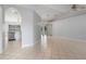 Spacious living room featuring tile flooring, neutral walls, vaulted ceiling, and chandelier lighting at 8408 Nuzum Rd, Brooksville, FL 34613