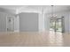 Open living space boasts tile floors, a chandelier, and sliding doors to a patio at 8408 Nuzum Rd, Brooksville, FL 34613
