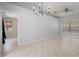 Bright living room featuring tile flooring, neutral walls, and a ceiling fan at 8408 Nuzum Rd, Brooksville, FL 34613