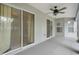 Screened-in porch featuring a ceiling fan and sliding glass doors at 8408 Nuzum Rd, Brooksville, FL 34613