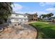 Spacious backyard with a fire pit, pool, and patio, complemented by lush landscaping and an inviting outdoor space at 8488 35Th N Ave, St Petersburg, FL 33710