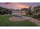 A large home has a perfectly manicured lawn, pool, fire pit, and a covered outdoor dining area at 8488 35Th N Ave, St Petersburg, FL 33710