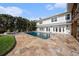Beautiful backyard featuring a pool, travertine patio, lush landscaping, and stunning waterfront views at 8488 35Th N Ave, St Petersburg, FL 33710