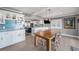 Modern dining area flows into a stylish kitchen featuring a charming breakfast bar at 8488 35Th N Ave, St Petersburg, FL 33710