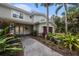 Charming home entrance with well-manicured garden, pathway, and double doors leading inside at 8488 35Th N Ave, St Petersburg, FL 33710