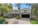 Charming home with lush landscaping and a spacious driveway leading to the entrance and garage at 8488 35Th N Ave, St Petersburg, FL 33710
