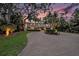 Elegant home featuring lush landscaping and a winding driveway under a colorful sky at 8488 35Th N Ave, St Petersburg, FL 33710