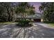 Elegant home with meticulous landscaping and a spacious circular driveway creating a welcoming ambiance at 8488 35Th N Ave, St Petersburg, FL 33710