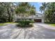 Elegant home with meticulous landscaping and a spacious circular driveway creating a welcoming ambiance at 8488 35Th N Ave, St Petersburg, FL 33710