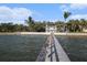 This waterfront home is surrounded by palm trees and has a private dock for relaxing by the water at 8488 35Th N Ave, St Petersburg, FL 33710