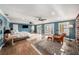 Spacious main bedroom with hardwood floors, ceiling fans, access to patio, and tranquil water views at 8488 35Th N Ave, St Petersburg, FL 33710