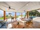 Covered patio with comfortable seating, ceiling fans, outdoor dining, and scenic waterfront views at 8488 35Th N Ave, St Petersburg, FL 33710