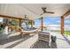 Relaxing covered patio with a hammock, ceiling fans, and stunning waterfront views at 8488 35Th N Ave, St Petersburg, FL 33710