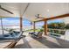 Inviting covered patio with a hammock, seating, ceiling fans, and gorgeous water views with a pool at 8488 35Th N Ave, St Petersburg, FL 33710