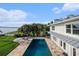 Aerial view of the luxurious pool and travertine patio area, surrounded by lush landscaping and serene waterfront at 8488 35Th N Ave, St Petersburg, FL 33710