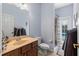 Bathroom featuring a light blue wall, framed mirror, and tile flooring at 9632 Asbel Estates St, Land O Lakes, FL 34638