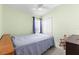 Bedroom with light green walls, ceiling fan and closet at 9632 Asbel Estates St, Land O Lakes, FL 34638