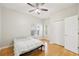 Comfortable bedroom with natural light, ceiling fan, closet, and wood floor at 10260 Devonshire Lake Dr, Tampa, FL 33647