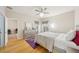 Well-lit bedroom with modern decor, plush bed, and view into connected office space at 10260 Devonshire Lake Dr, Tampa, FL 33647