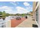 Community deck overlooking a tranquil lake with seating and manicured landscaping at 10260 Devonshire Lake Dr, Tampa, FL 33647