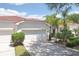 Charming home featuring a 2-car garage, tile roof, and lush landscaping at 10260 Devonshire Lake Dr, Tampa, FL 33647