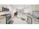 Bright kitchen featuring stainless steel appliances, granite countertops, and ample storage space at 10260 Devonshire Lake Dr, Tampa, FL 33647