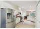Well-equipped kitchen with stainless steel appliances and white cabinetry, open to the living spaces at 10260 Devonshire Lake Dr, Tampa, FL 33647